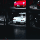 A dark garage filled with classic and exotic cars similar to the ones auctioned off by Barrett-Jackson